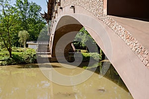 Covered arch bridge over river