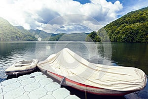 Covered boat parked on Vidraru Lake