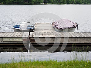 Covered Boats Tied to Lake Dock