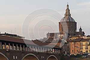 Covered bridge and Pavia cathedral in Pavia at sunset