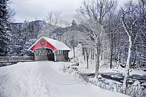 Covered bridge snowfall in rural New Hampshire photo