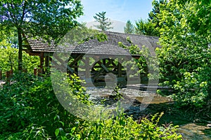 Covered Bridge with Trees along the Naperville Riverwalk over the DuPage River