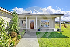 Covered entrance porch with concrete floor and columns