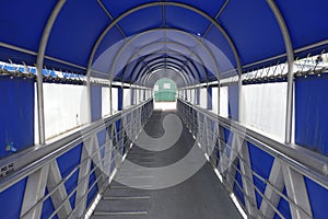 A covered gangway leading to boats