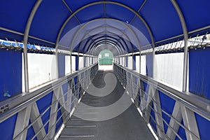 A covered gangway leading to boats photo