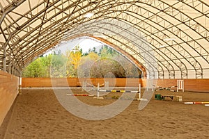 Covered open horse arena with sand. photo