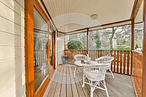 a covered porch with a table and chairs on it