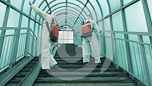 Covered staircase is getting disinfected by sanitation workers