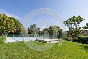 Covered swimming pool of an urbanization with many gardens and a lot of grass