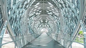 covered walkway bridge It is a tall arch. The design is modern.