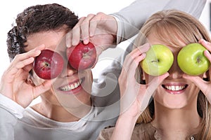 Covering her eyes with apples