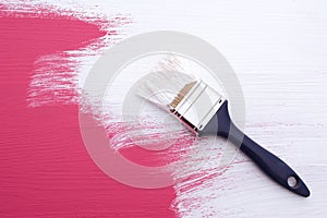 Covering pink paint with a coat of white emulsion