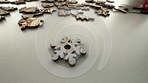 Covering a wooden snowflake with silver paint. DIY Christmas ornaments. Xmas decorations using organic blanks and white