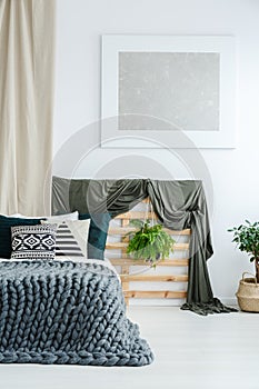 Coverlet on wooden bedhead photo