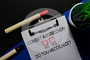 Covert Aggression, Do You Recognize? Yes or No. On office desk background