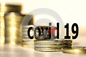 ,, Covid 19 ` on a background of coins and money .