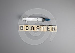 Covid-19 booster shots vaccine text on Gray background Covid-19 booster shots, with syringe top view and copy space