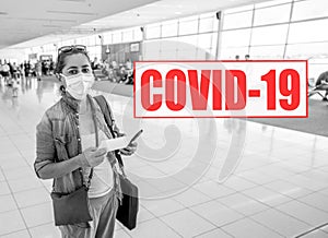 COVID-19 Border closures. Traveler woman with face mask stuck at international airport