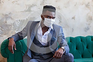 COVID-19. Confident young African man is wearing a protective medical face mask to prevent infection with coronavirus