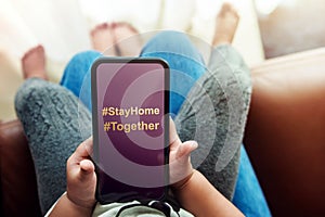 Covid-19 or Corona Virus Situation Concept. Hashtag Sign to Stay Home and Together showing on Mobile Phone Screen. Family Time