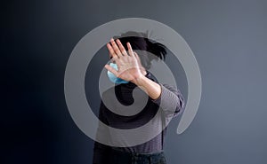 Covid-19 or Corona Virus Situation Concept. Young Woman with Medical Mask Keeping her Personal Clean Zone by Stop Sign Gesture