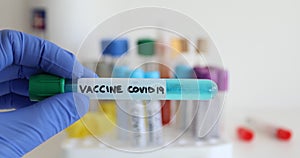 Covid-19 coronavirus flu test tube with vaccine in biotechnology research laboratory