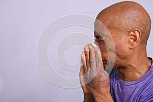 COVID-19 Coronavirus  pandemic outbreak man blowing his nose stock photo