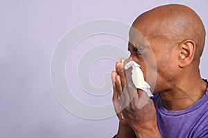 COVID-19 Coronavirus  pandemic outbreak man blowing his nose stock photo