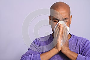 COVID-19 Coronavirus  pandemic outbreak man blowing his nose stock photo