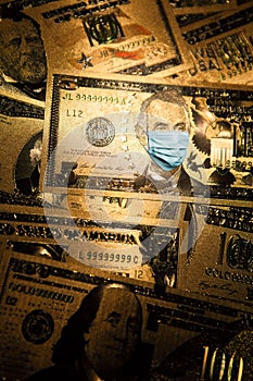 COVID-19 coronavirus in USA. Five golden dollar money bill with face mask.