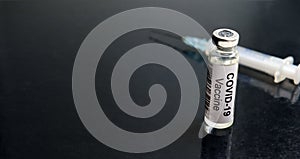 COVID-19 coronavirus vaccine background, panoramic view of vaccine bottle and syringe for corona virus cure