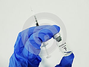 Covid-19 Coronavirus Vaccine. Hand glove, drug vial and syringe