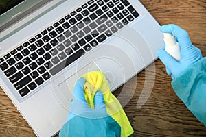COVID-19 Coronavirusdisinfection of workspace cleaning disinfecting wipes to wipe surface of desk, keyboard, mouse at office. Stop