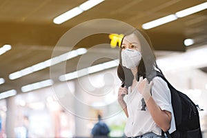 COVID-19 Crisis, Asian travelers girl and surgical mask in airports