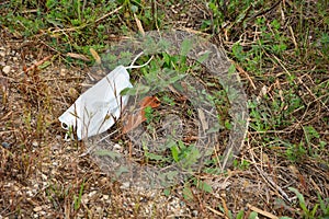 Covid-19 Discarded Facemask on Side of Road