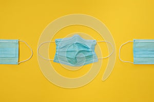 COVID-19 disposable surgical face masks on yellow background