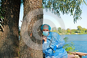 COVID-19. Doctor in medical facial mask hold stethoscope and exam tree patient. M