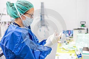 Covid-19. Female nurse puts on protective gloves. Personal protective equipment in the fight against Coronavirus disease