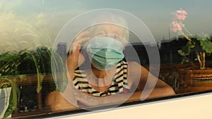 The Covid-19, health, safety and pandemic concept - senior old lonely woman sitting near the window