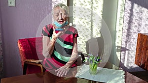 The Covid-19, health, safety and pandemic concept - senior old lonely woman sitting with phone