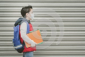 Covid-19,kid with medical mask and backpack who walks to school