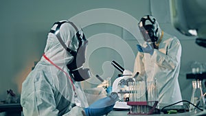 COVID-19 laboratory, coronavirus antibodies research concept. Laboratory experts are working with glass tubes