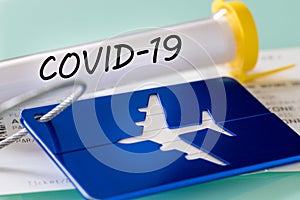 Covid-19.  Laboratory vial, boarding pass and luggage tag. Concept of Airline financial problems due to the virus