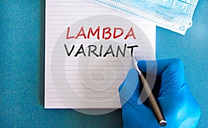 Covid-19 lambda variant strain symbol. Hand in blue glove with white card. Concept words lambda variant. Metalic pen. Medical,