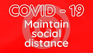 COVID - 19 Maintain Social Distance Inscription On Red Background