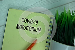 Covid-19 Moratorium write on a book isolated on office desk