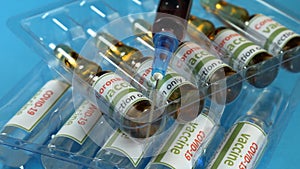 Covid-19 and ncov coronavirus vaccine, tablets and syringe. Laboratory, analyzes a colored liquid to extract the DNA and