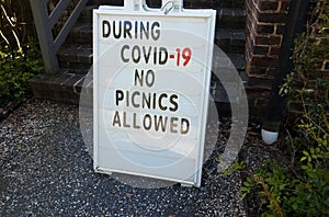 During covid 19 no picnics allowed sign on gravel