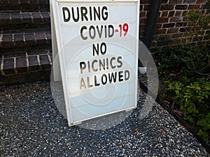 During covid 19 no picnics allowed sign on gravel