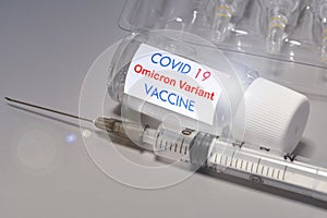 Covid-19 Omicron variant strain vaccine. Syringe and vaccine. Treatment for coronavirus covid-19